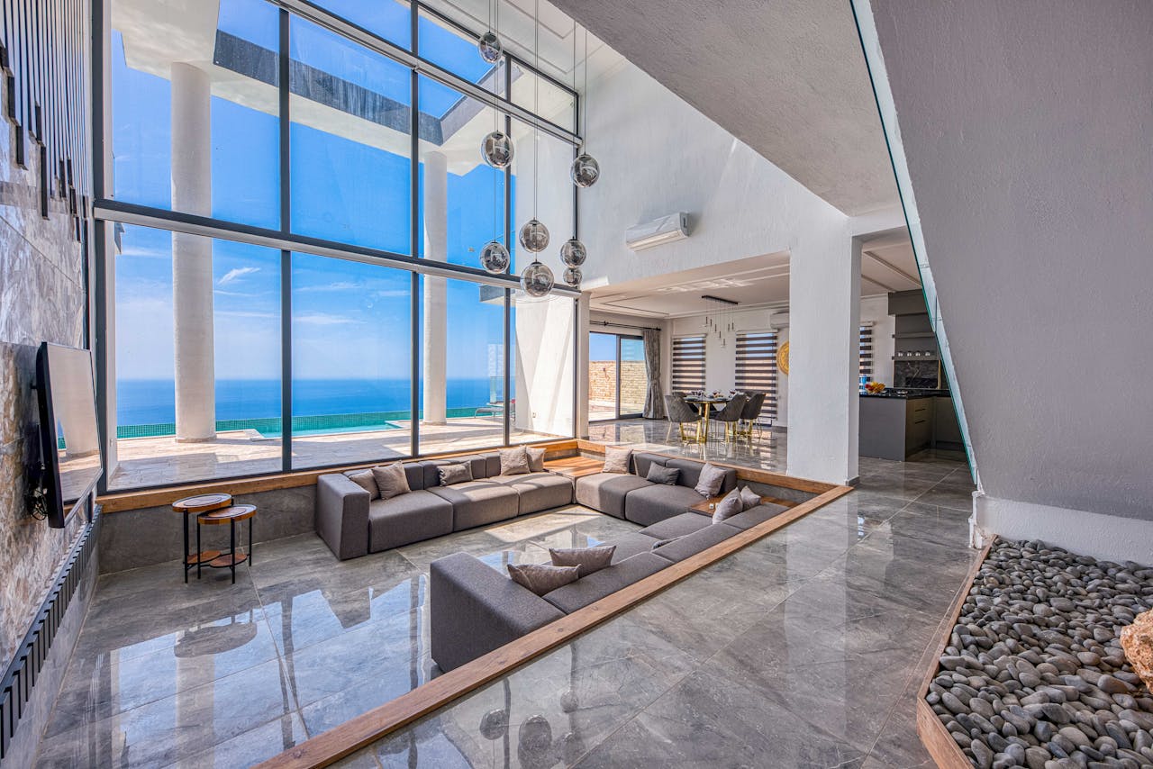Spacious modern living room with stunning ocean view through large windows.
